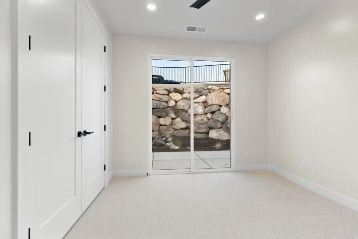 Sliding glass door opening to a stone retaining wall