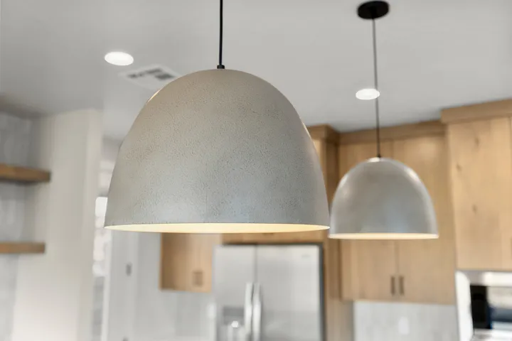 Contemporary pendant lighting fixtures with a textured, light-toned finish
