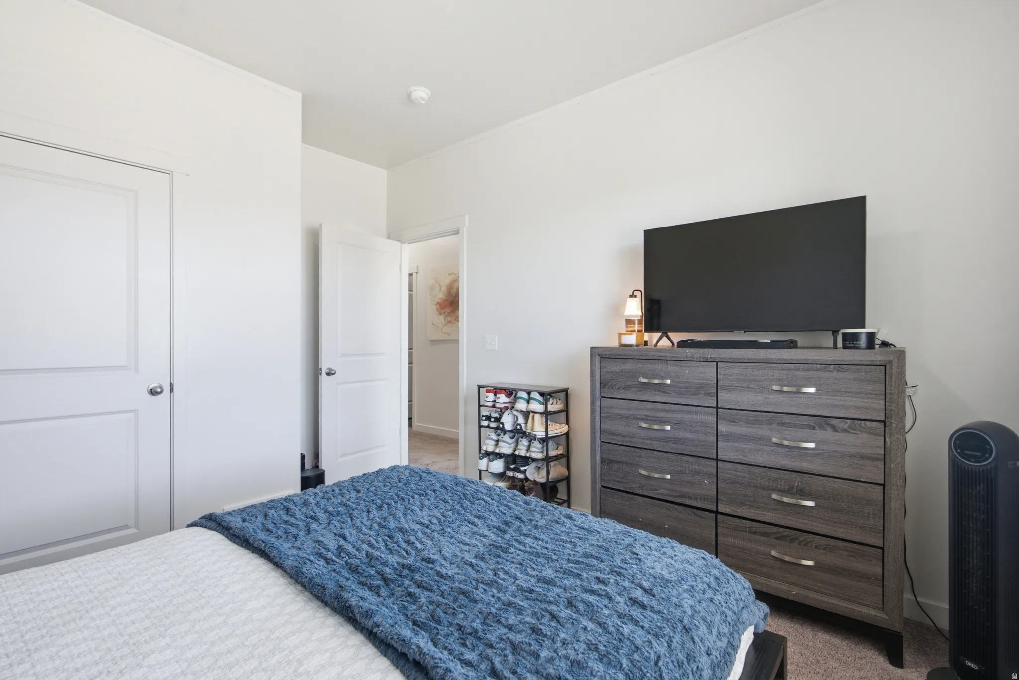 Bedroom featuring light-colored walls and neutral carpeting