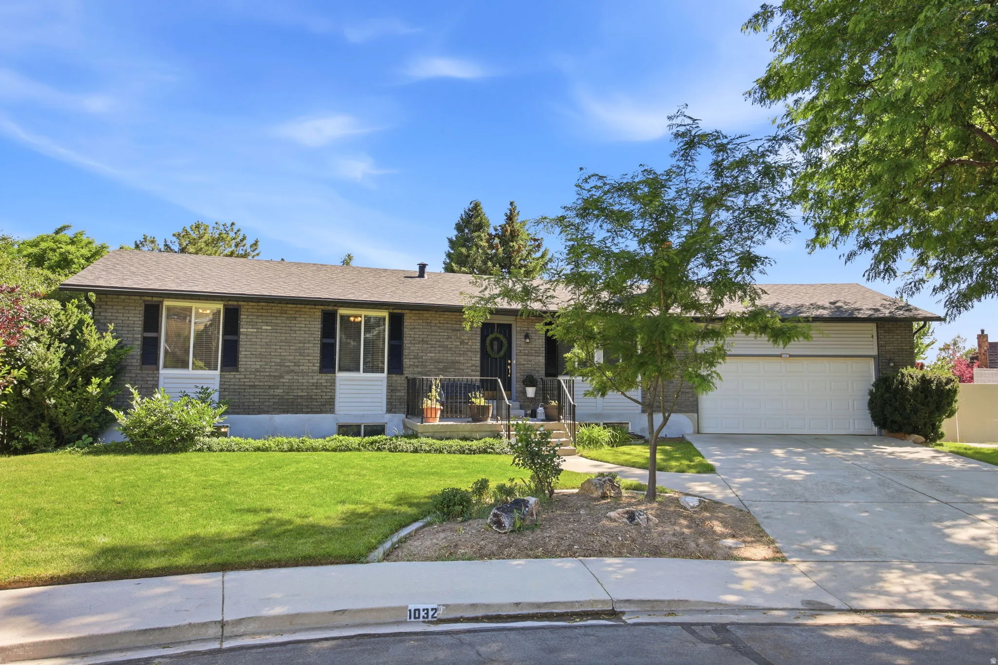 Brick veneer exterior with a concrete driveway and two-car garage