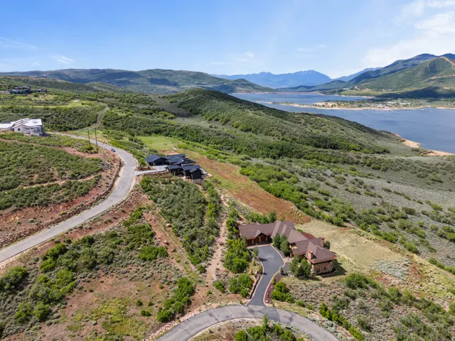 Aerial perspective showcasing the property's elevated position with lake and mountain scenery