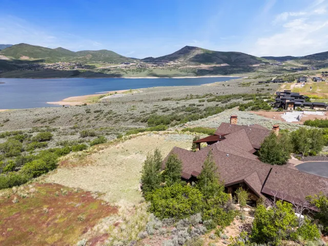 Expansive property featuring a multi-gabled roofline, multiple chimneys, and a paved driveway