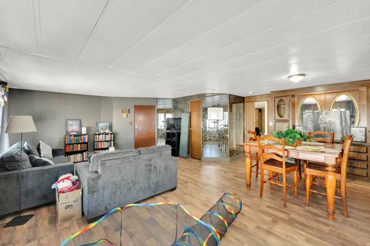 Open-concept interior featuring wood-finish flooring and a white panel ceiling