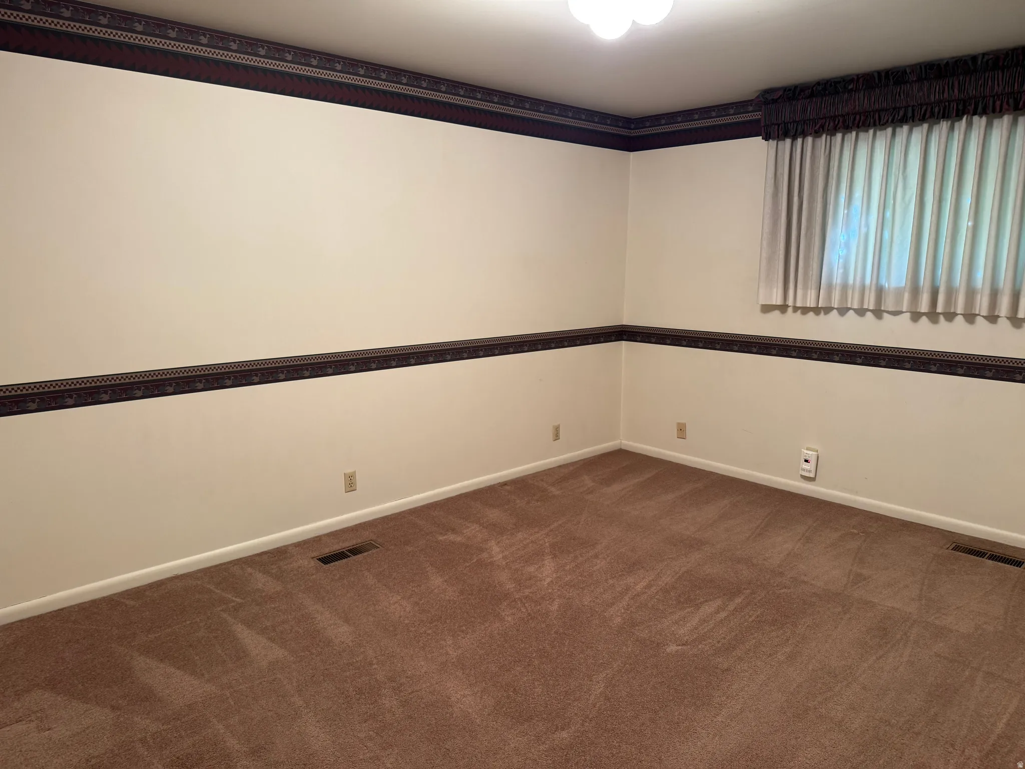 Neutral wall colors complemented by patterned wallpaper borders