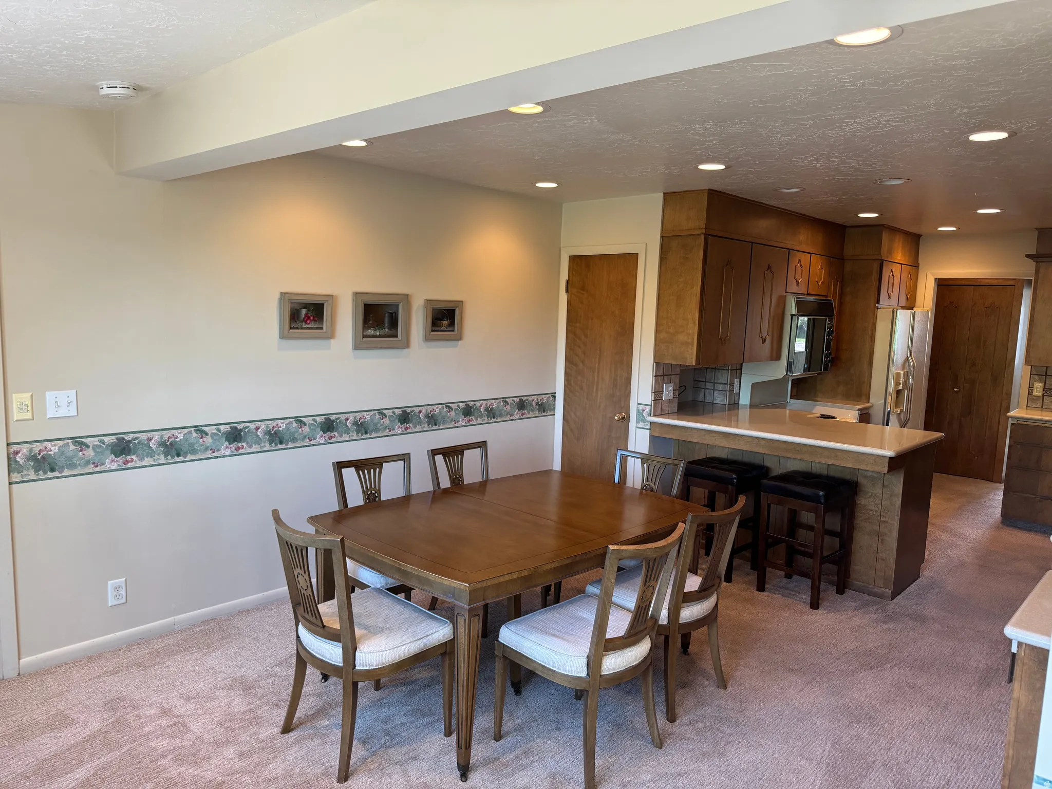 Dining area with recessed lighting, integrated into an open-concept layout