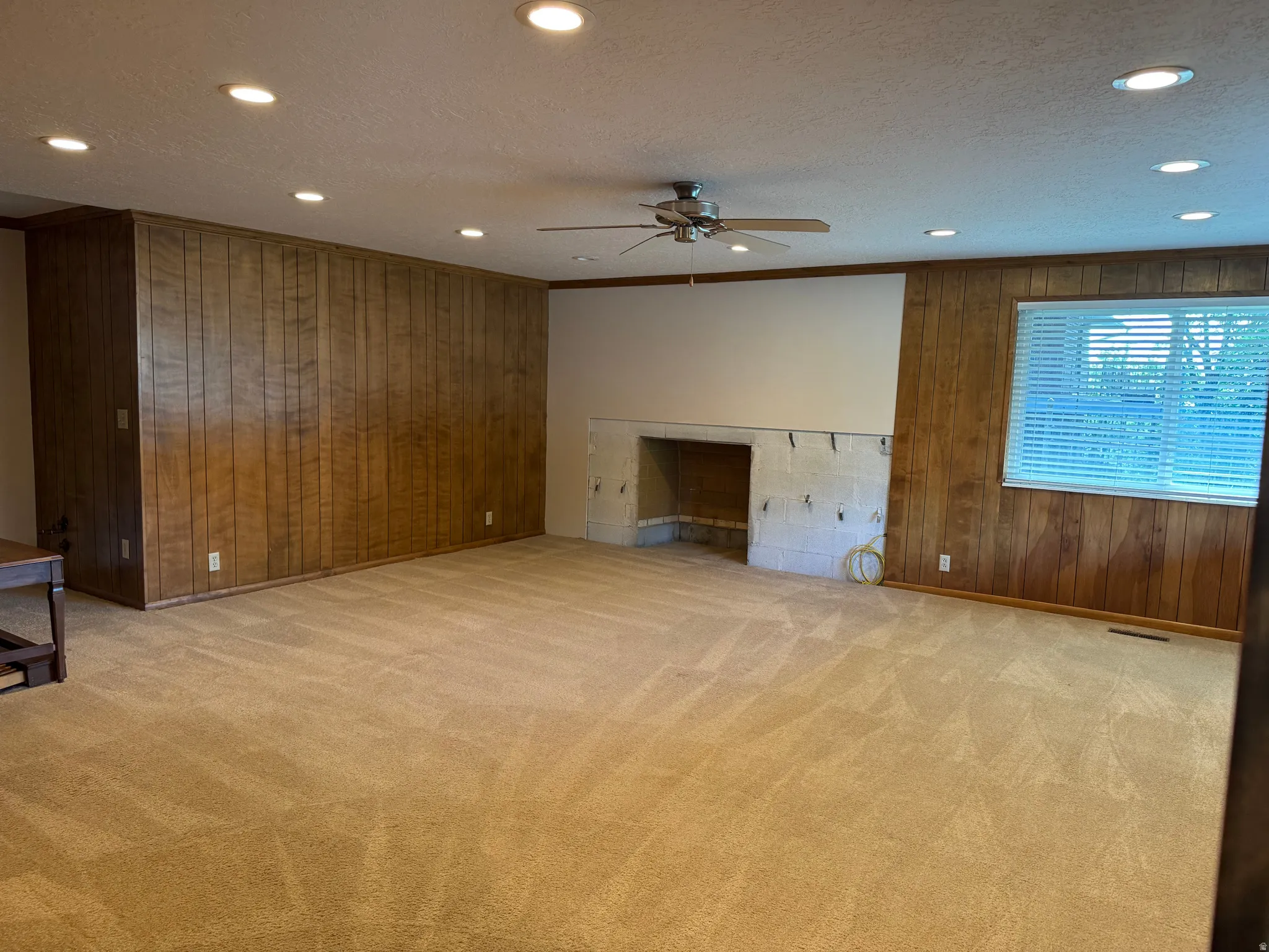 Expansive room featuring recessed lighting, a ceiling fan, and carpet flooring