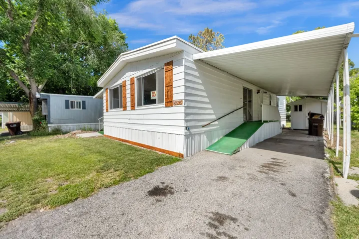 White siding exterior with brown window shutters