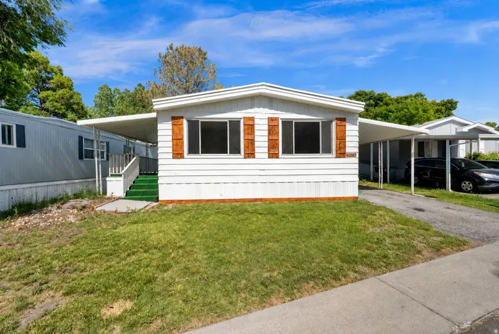 White siding exterior with brown wood shutters