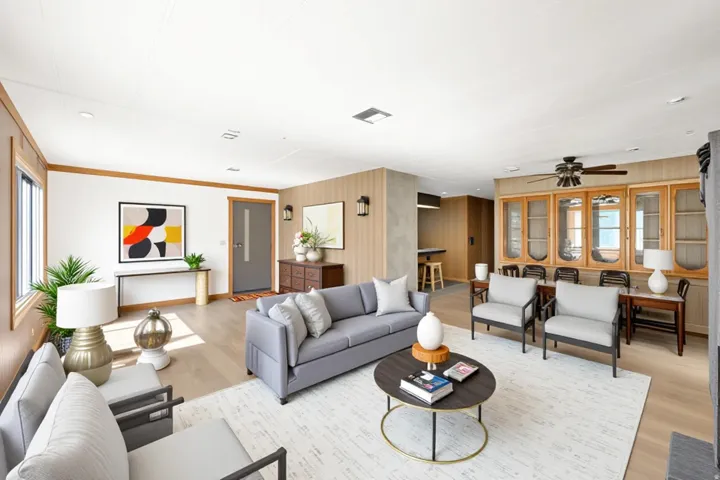 Open-concept living space featuring wood-finish flooring, recessed lighting, and a neutral color palette