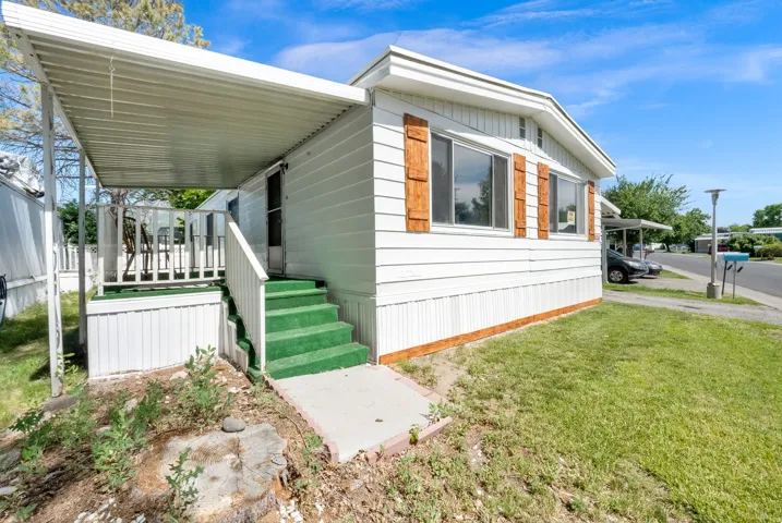 White exterior with wood-finish shutters and a covered porch