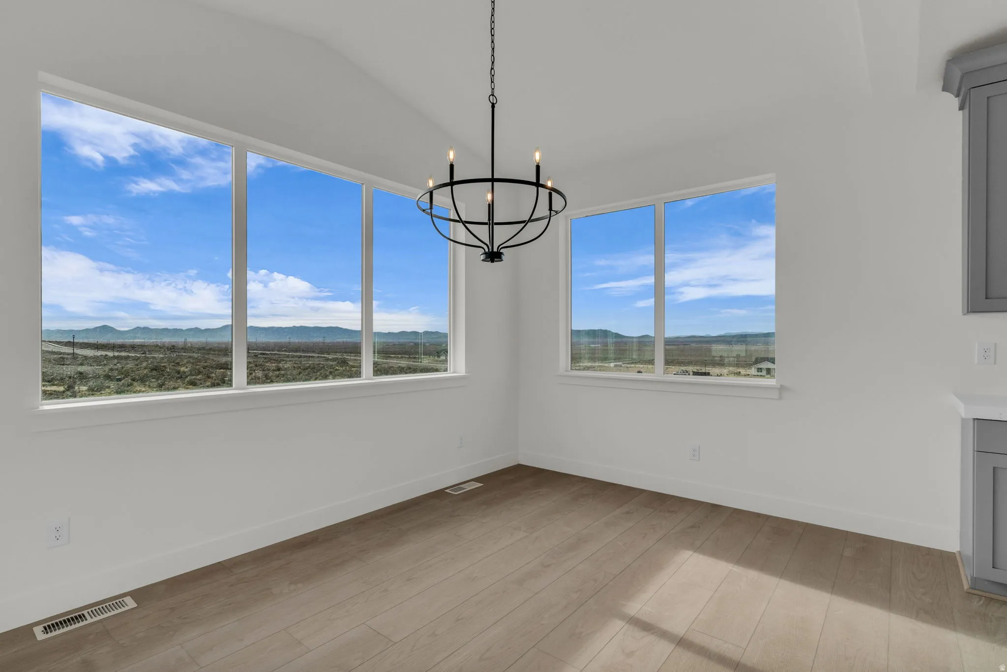 Full-size dining area with great views and chandelier adjacent to kitchen.