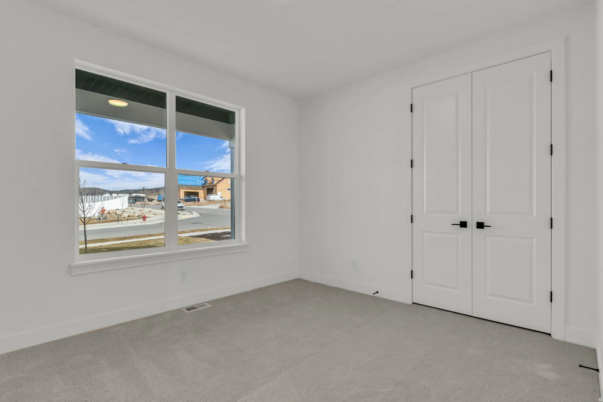 Bedroom #2 with large closet and vaulted ceiling.