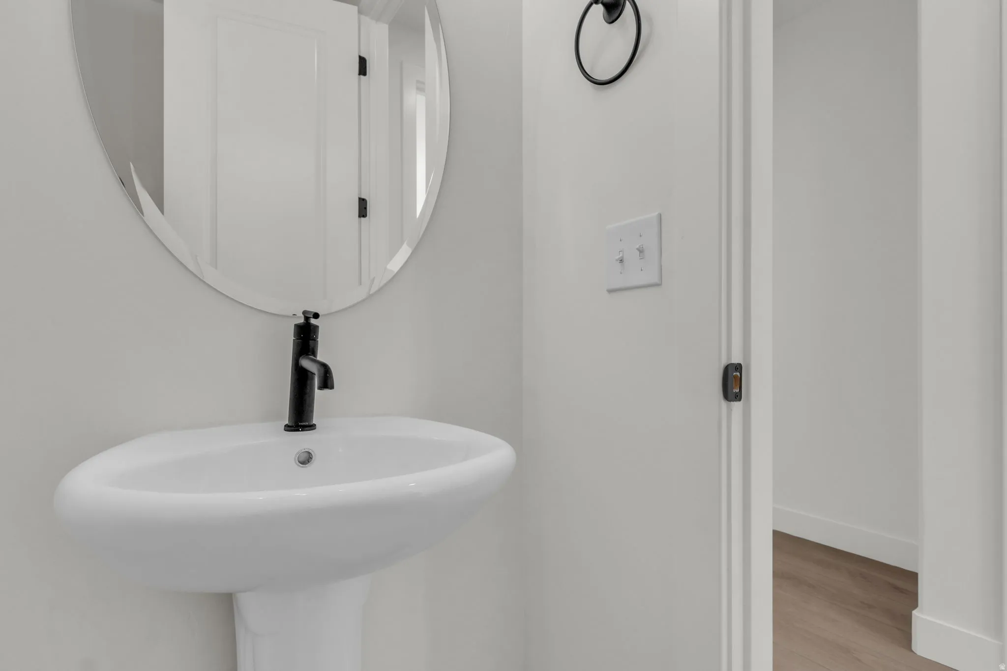 Powder bath adjacent to laundry room and garage.
