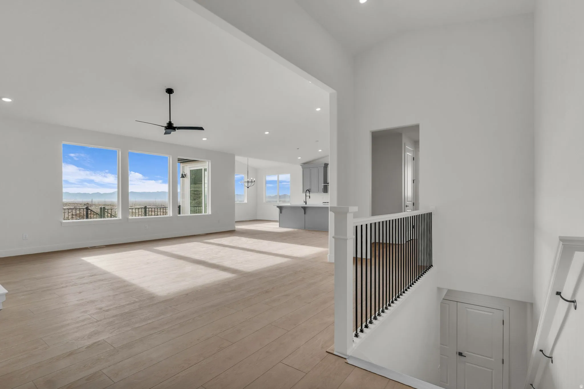 Spacious great room/family room with vaulted ceiling and ceiling fan.