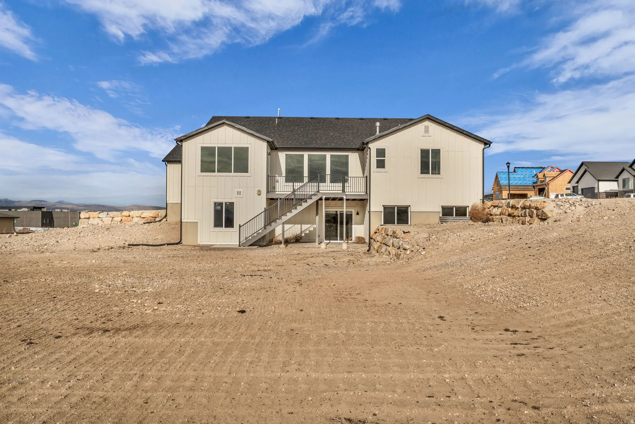 Rear view of walk-out basement and elevated porch with backyard.