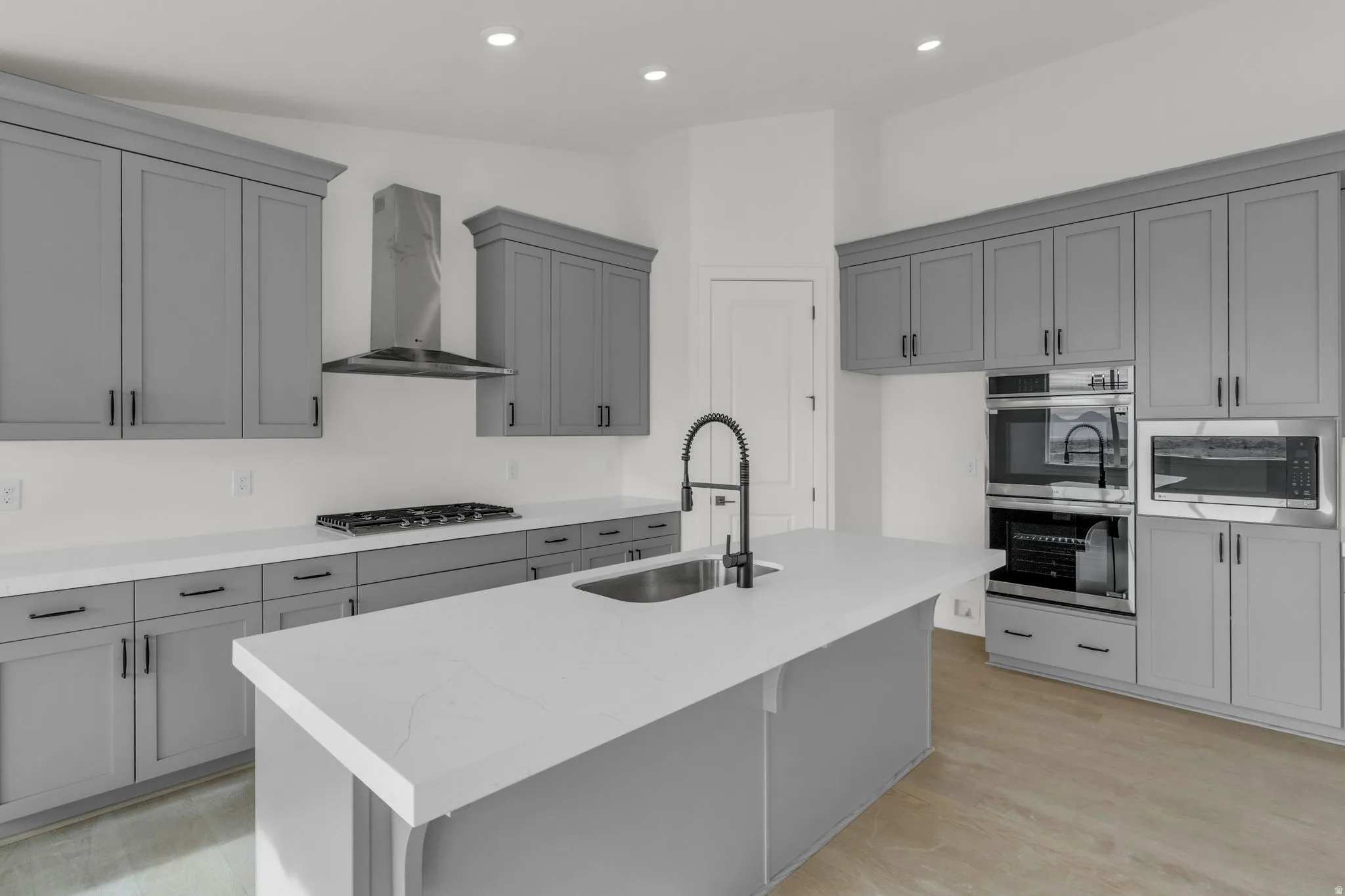 Great kitchen, vaulted ceiling, full-height uppers, painted wood cabinets, quartz slab countertops, double wall oven, gas cooktop range, range hood, microwave, dishwasher and disposal.