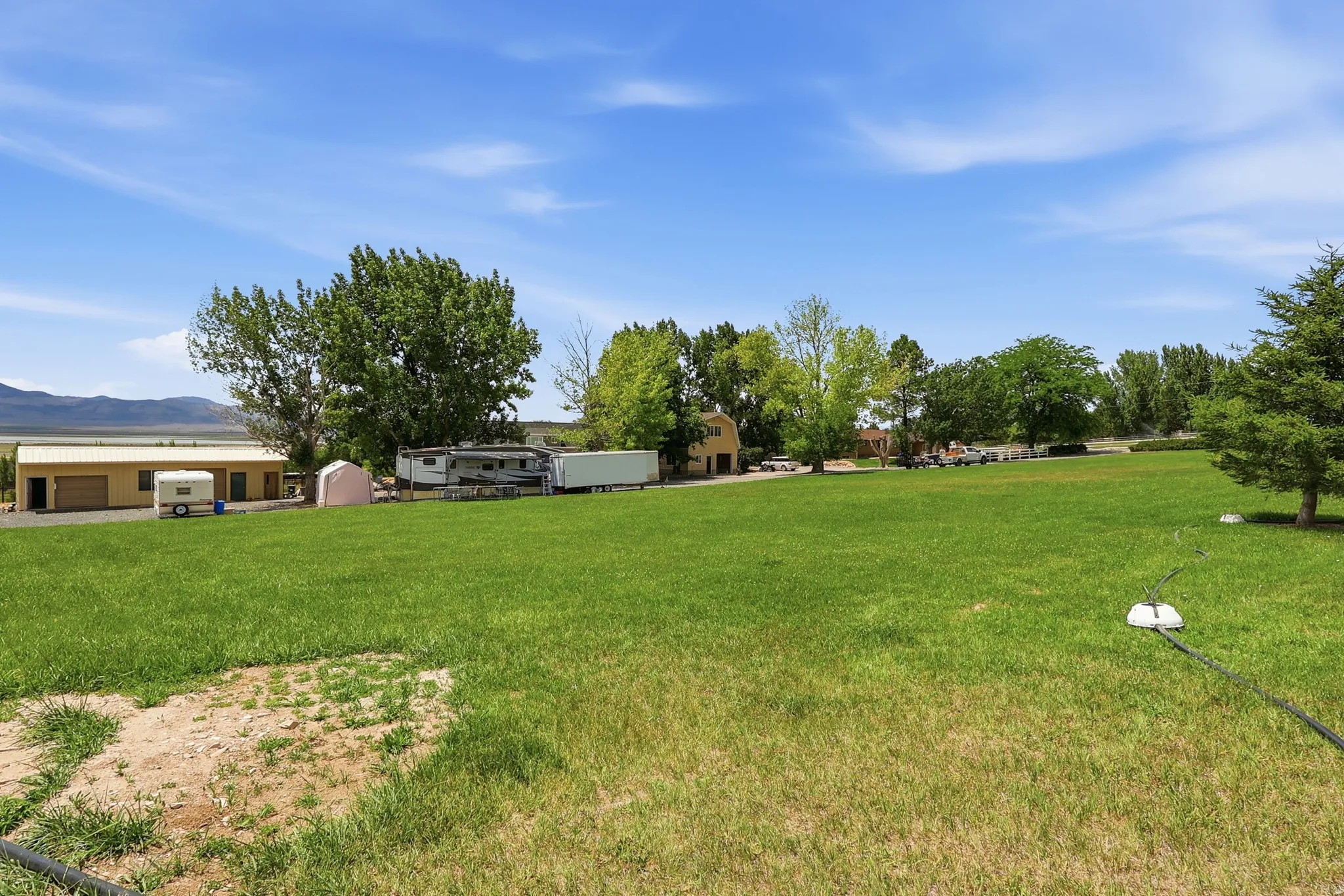 Expansive green lawn with distant mountain backdrop