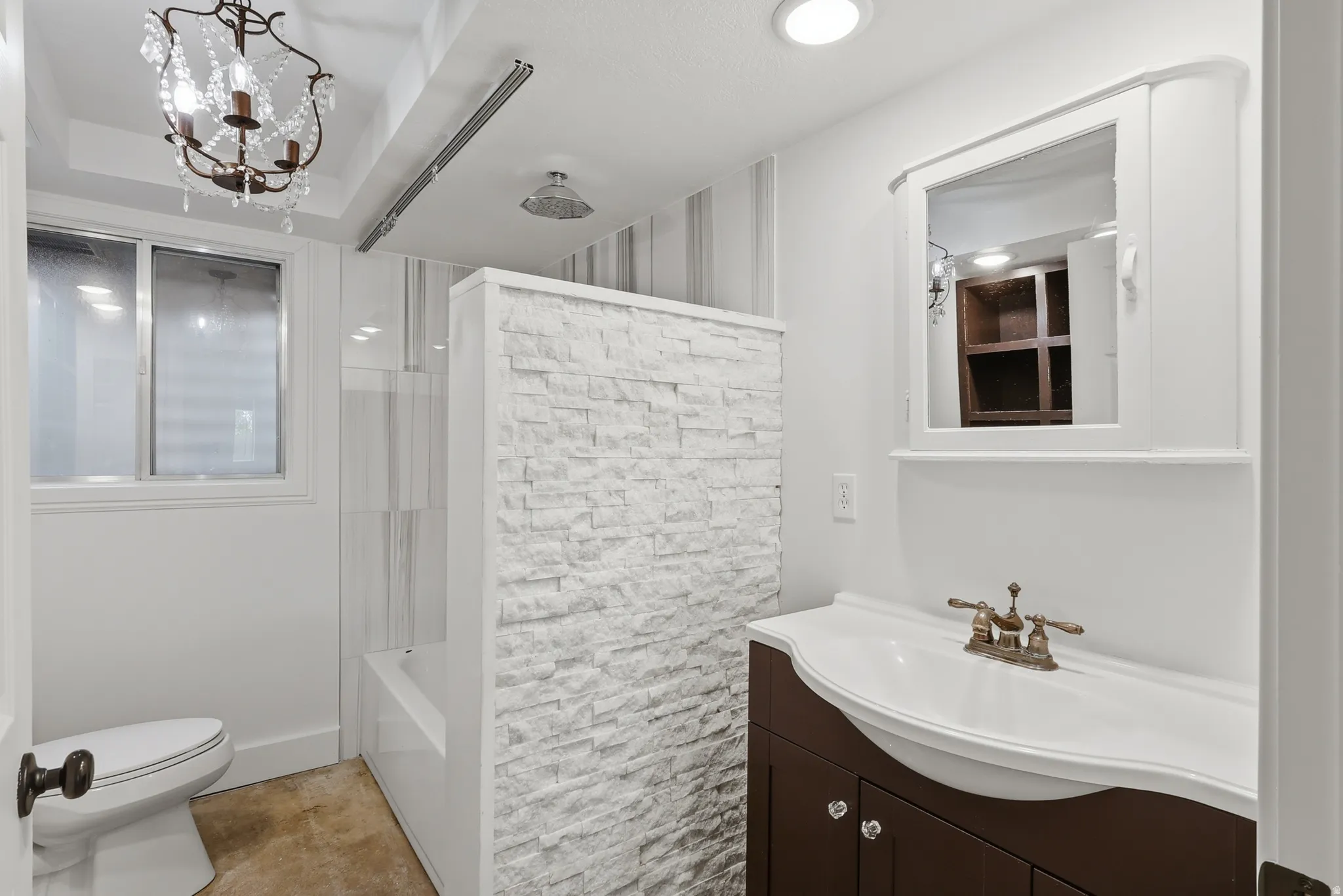 Bathroom with a vanity featuring a dark wood-finish cabinet and an integrated sink