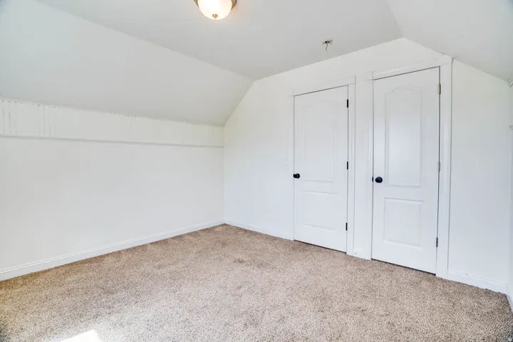 Neutral-toned carpet flooring complementing bright white walls