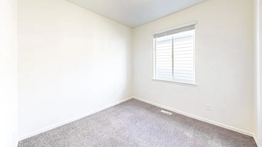 Neutral-toned wall paint and grey carpet flooring