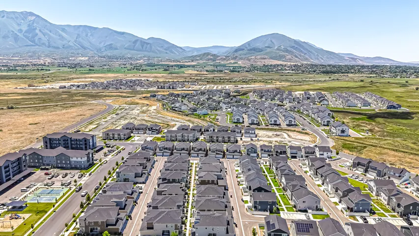 Newly constructed residential development featuring a varied architectural style of homes and multi-story apartment buildings