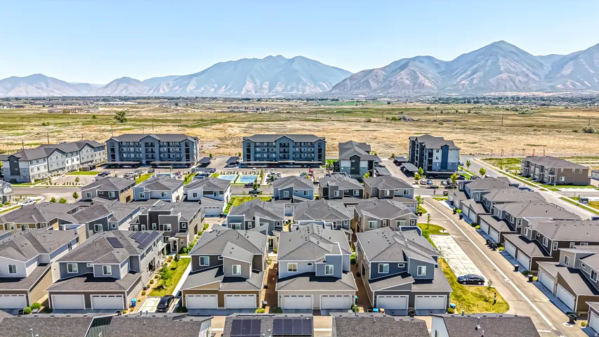 Modern residential development featuring single-family homes and multi-story apartment buildings