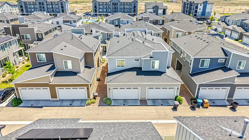 Modern residential development featuring multi-level homes with attached two-car garages