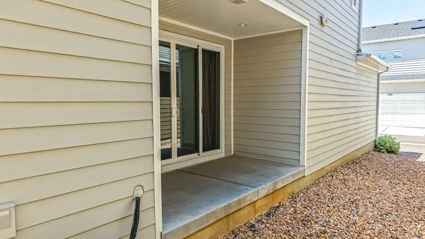 Ground-level patio featuring a sliding glass door entry and recessed lighting