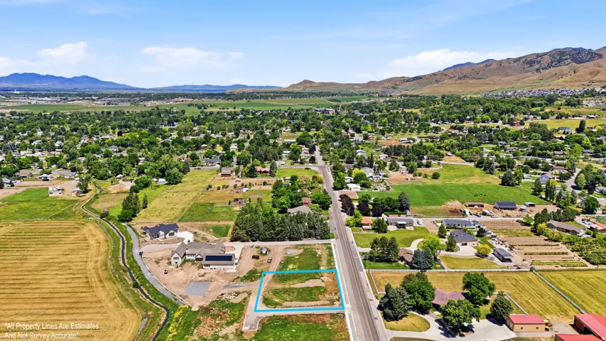 Expansive parcel featuring a clear building area, established road frontage, and a surrounding landscape of verdant fields