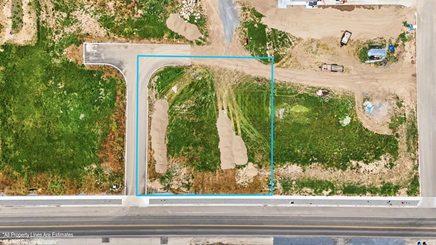 Corner lot featuring an established curb cut and direct road frontage