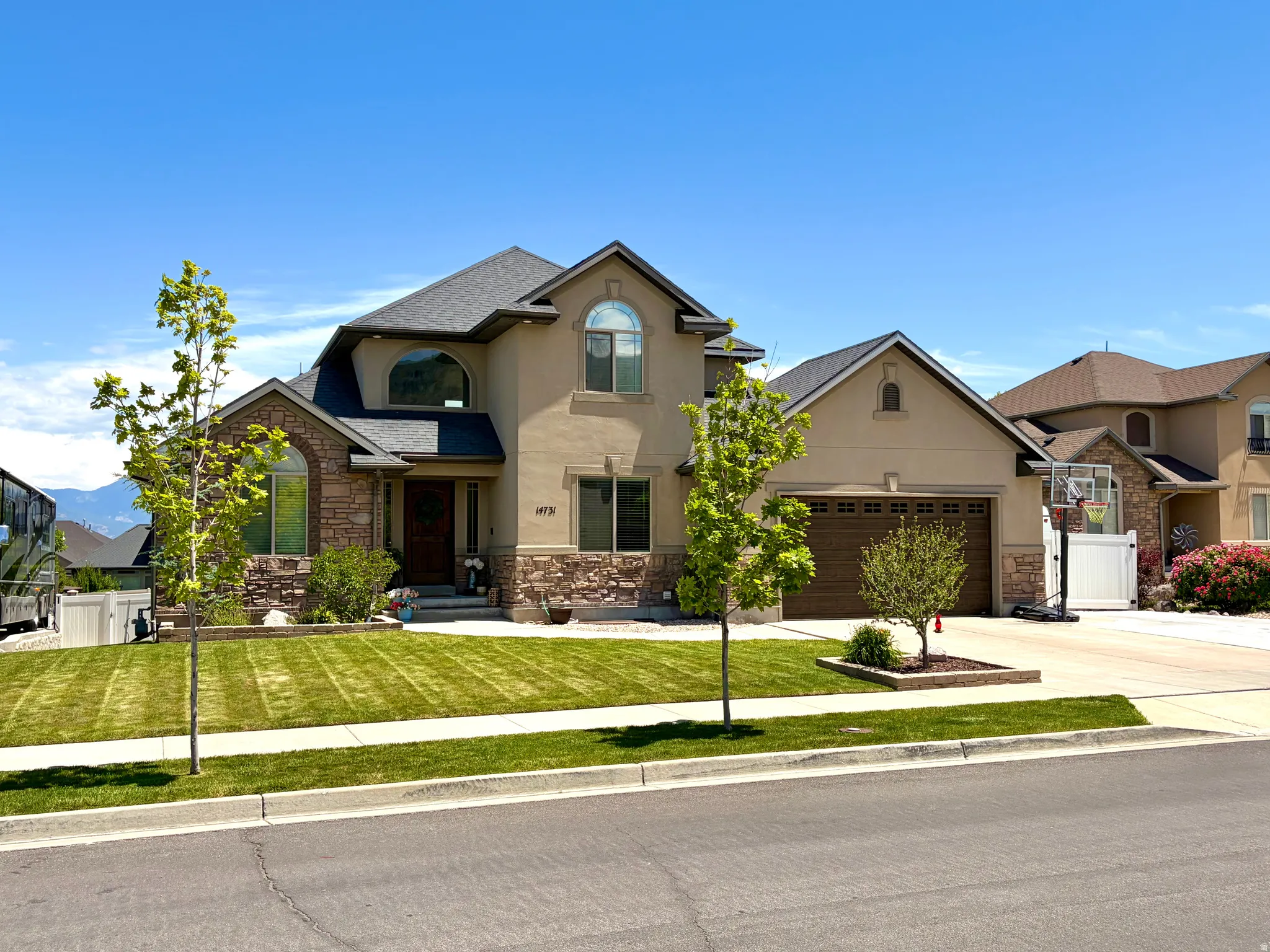 Stucco and stone facade property with an attached two-car garage