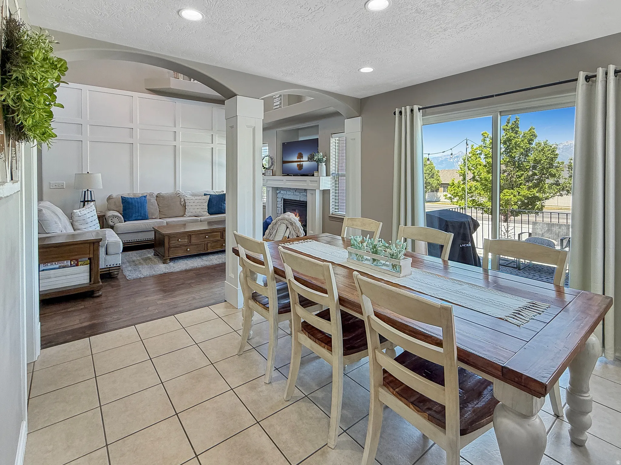 Dining area featuring tile flooring, a large sliding glass door, and recessed lighting