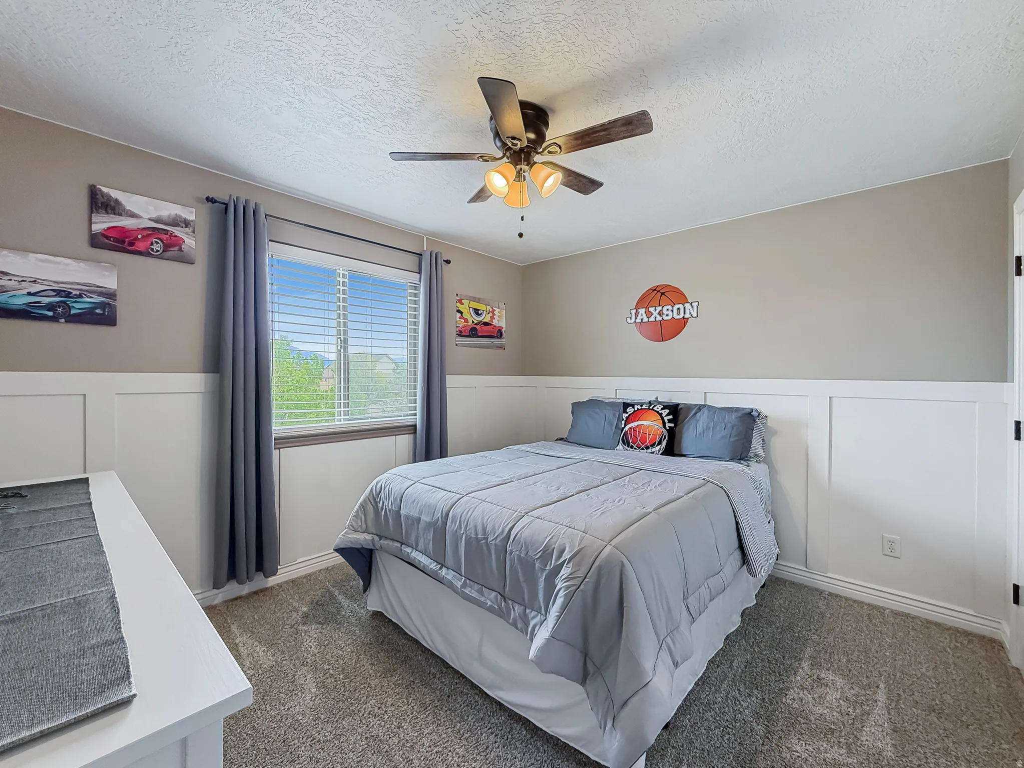 Bedroom featuring a window with blinds, a ceiling fan with integrated lighting, and carpet flooring