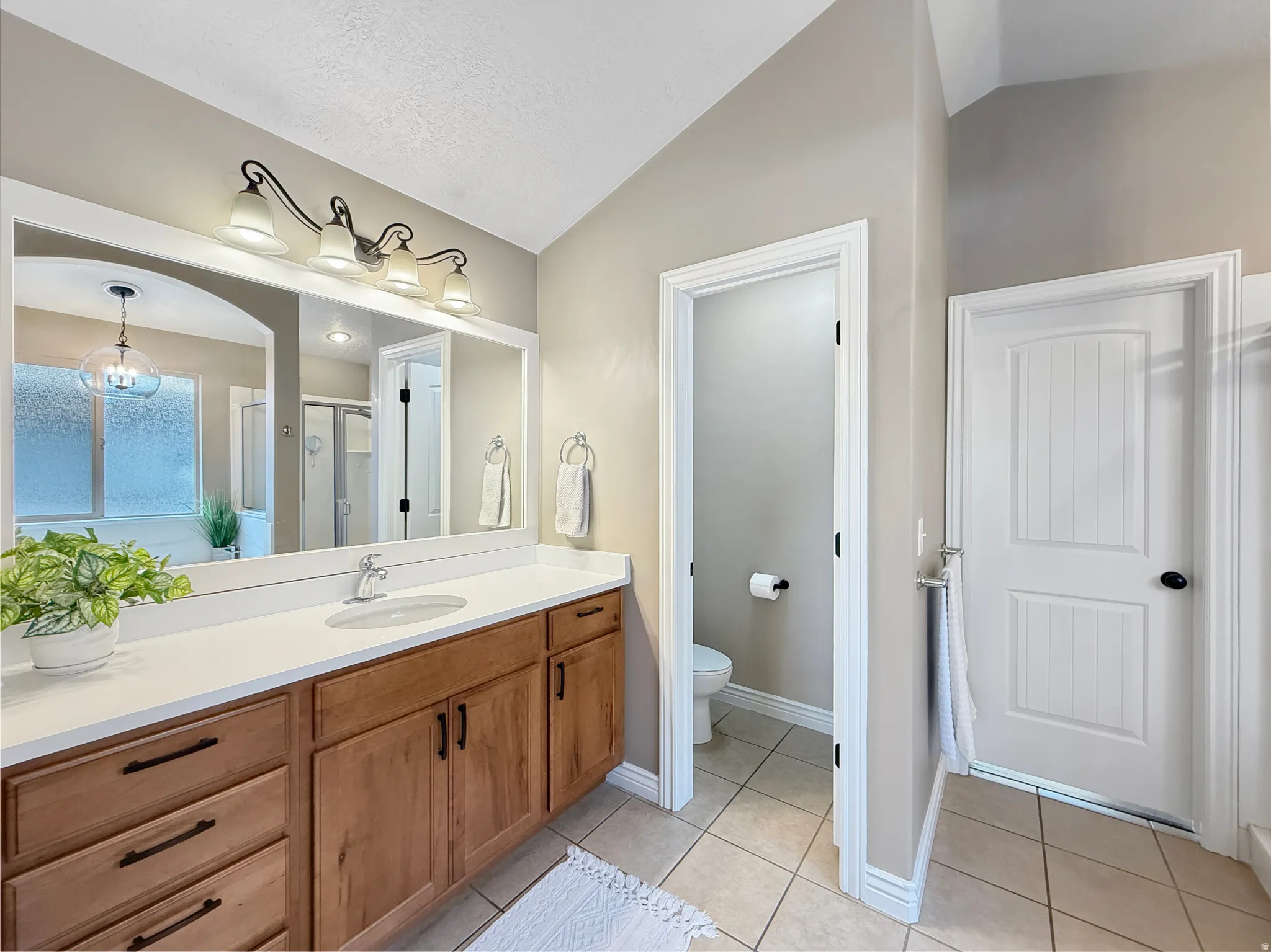 Bathroom featuring a double vanity with wood cabinetry, white countertops, and brushed nickel hardware