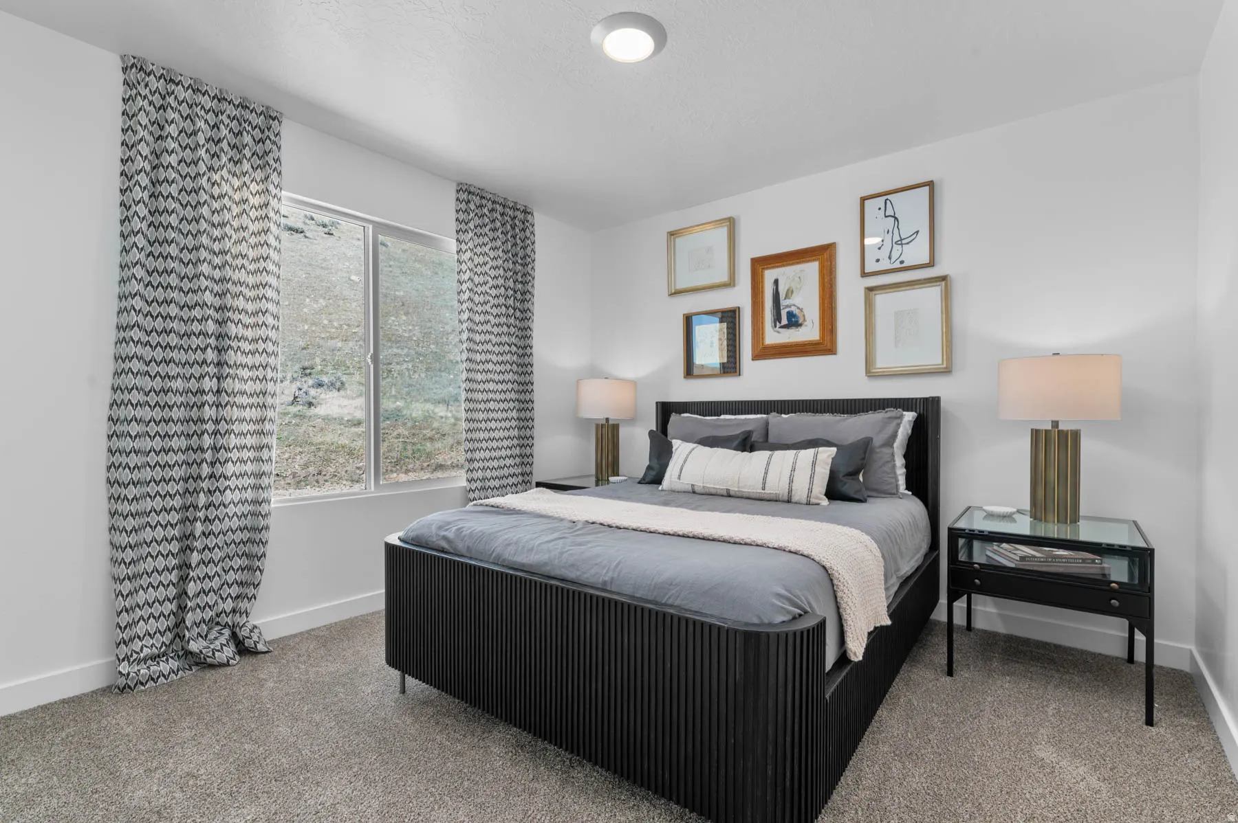 Carpeted bedroom with a large window