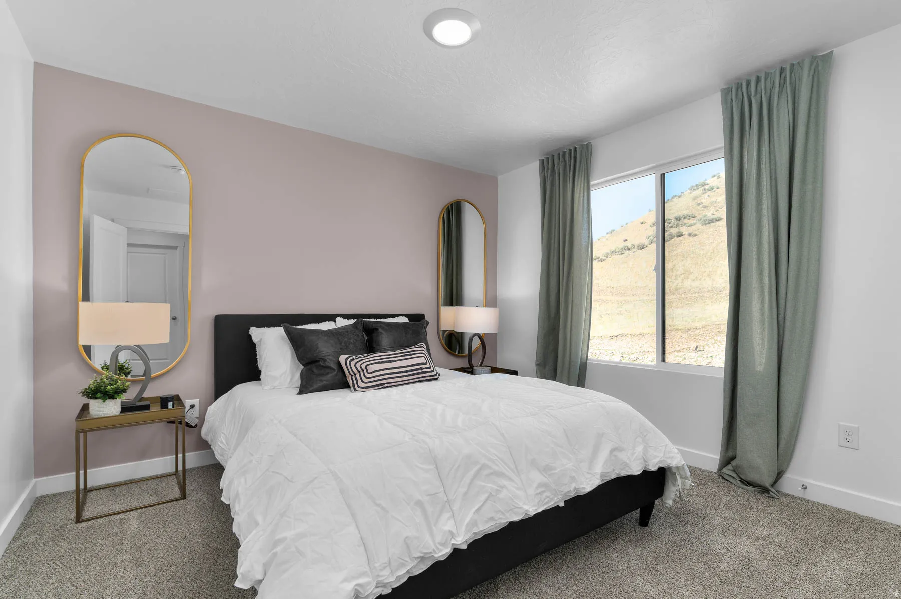 Spacious room featuring a large window, light gray carpeting, and a recessed ceiling light