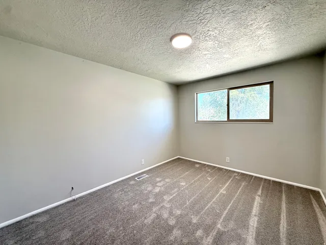 Neutral-toned walls complement the textured ceiling