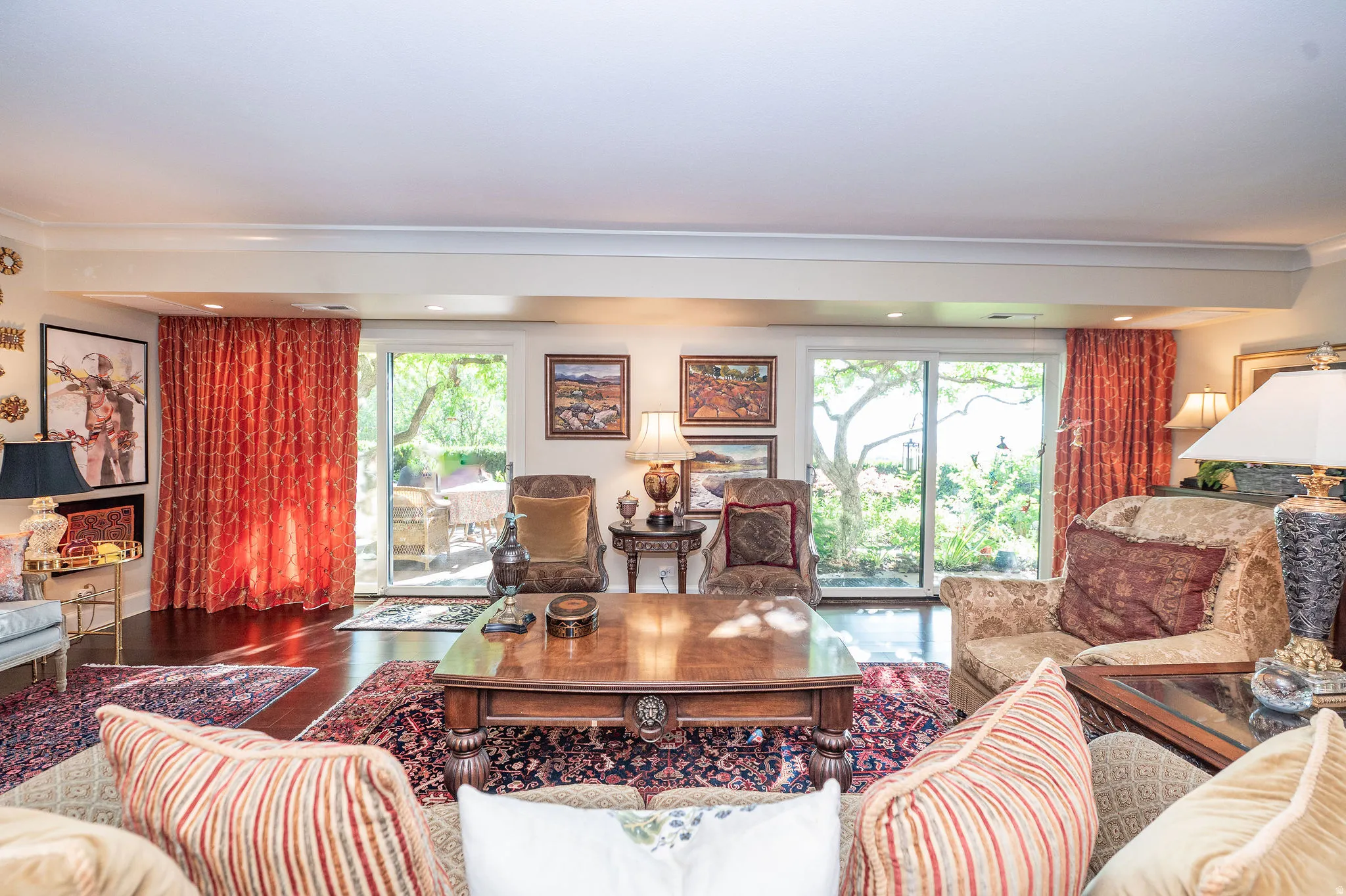 Living area featuring rich wood-finish flooring and recessed lighting