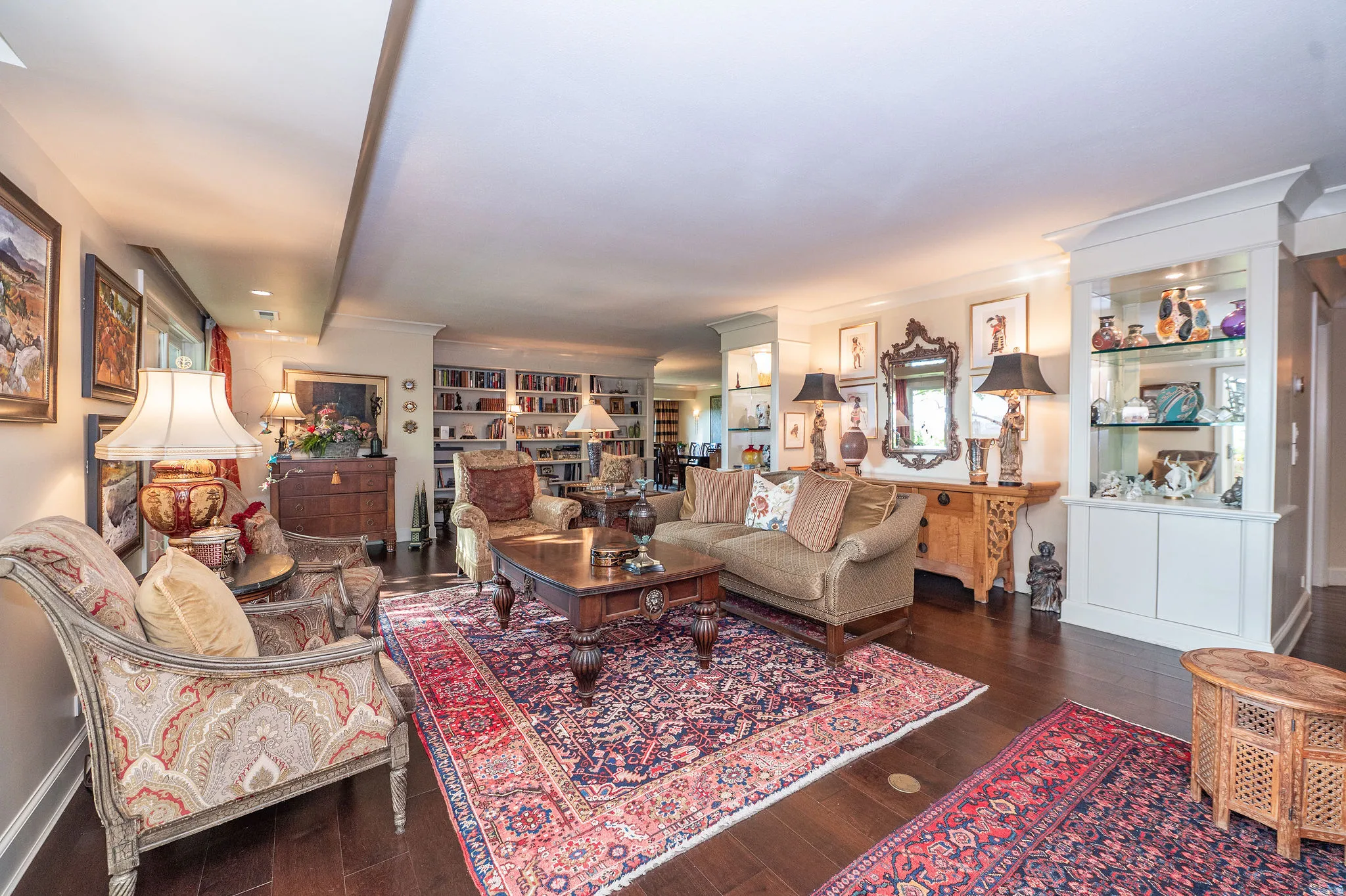 Expansive living area featuring rich wood-finish flooring