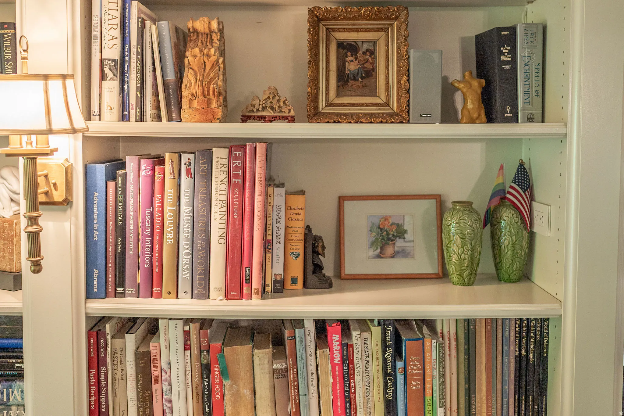 Built-in shelving unit featuring multiple display shelves and a wall-mounted light fixture