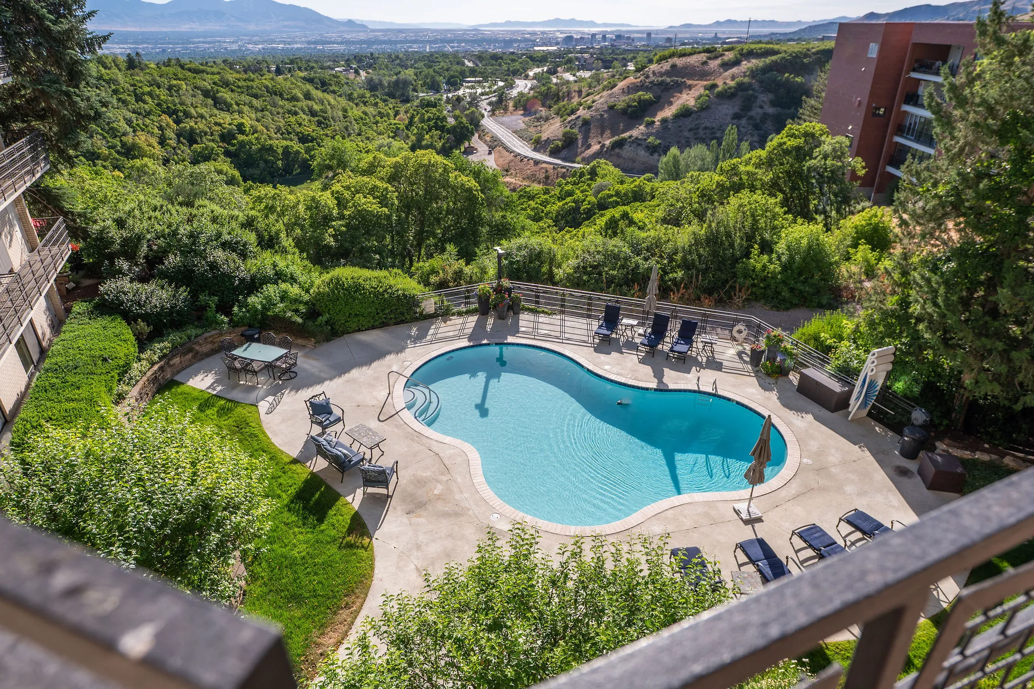 Freeform swimming pool with integrated steps and surrounding concrete patio