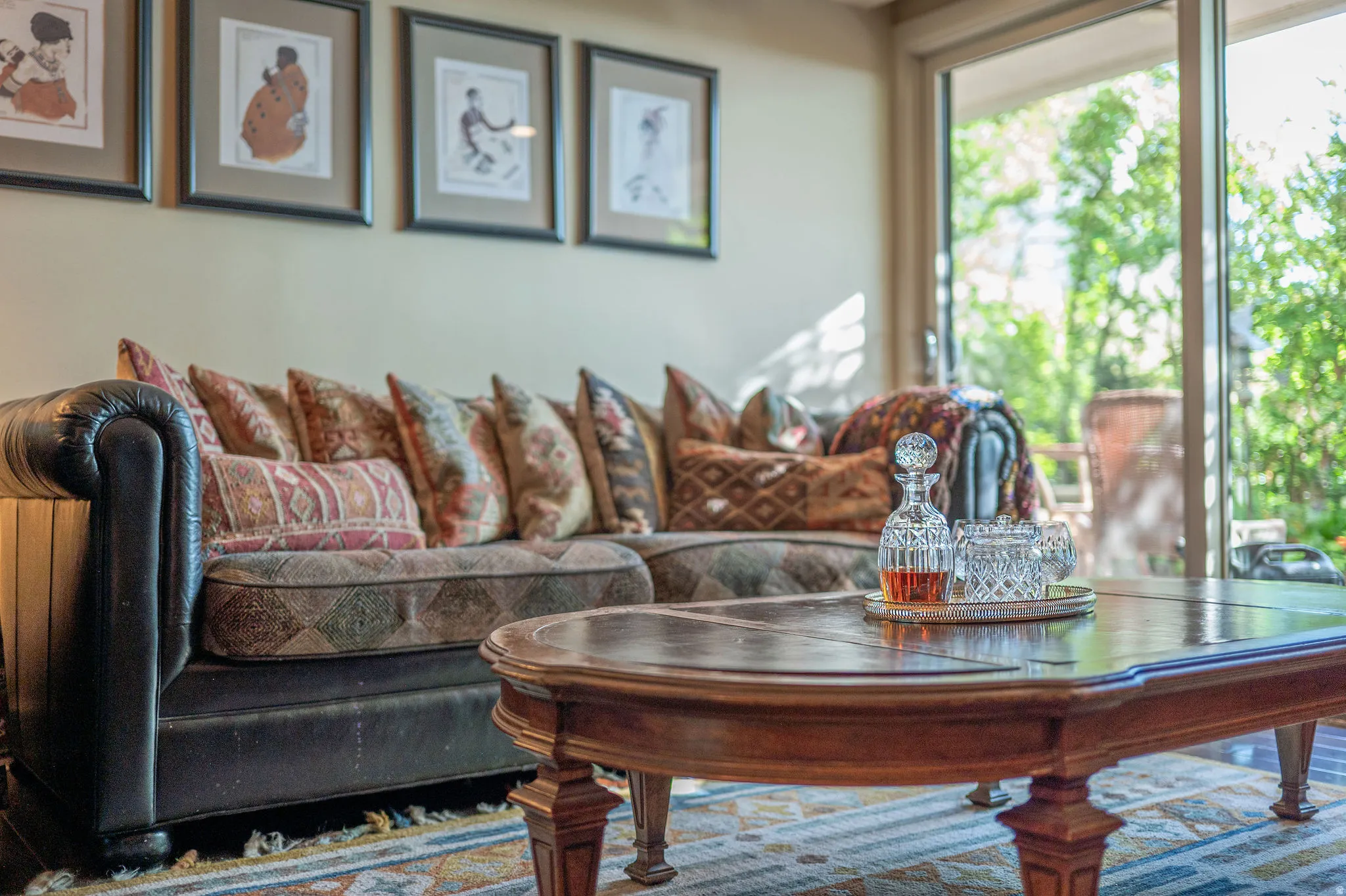 Spacious living area featuring expansive glass sliding doors, wood-finish flooring, and ample wall space for artwork