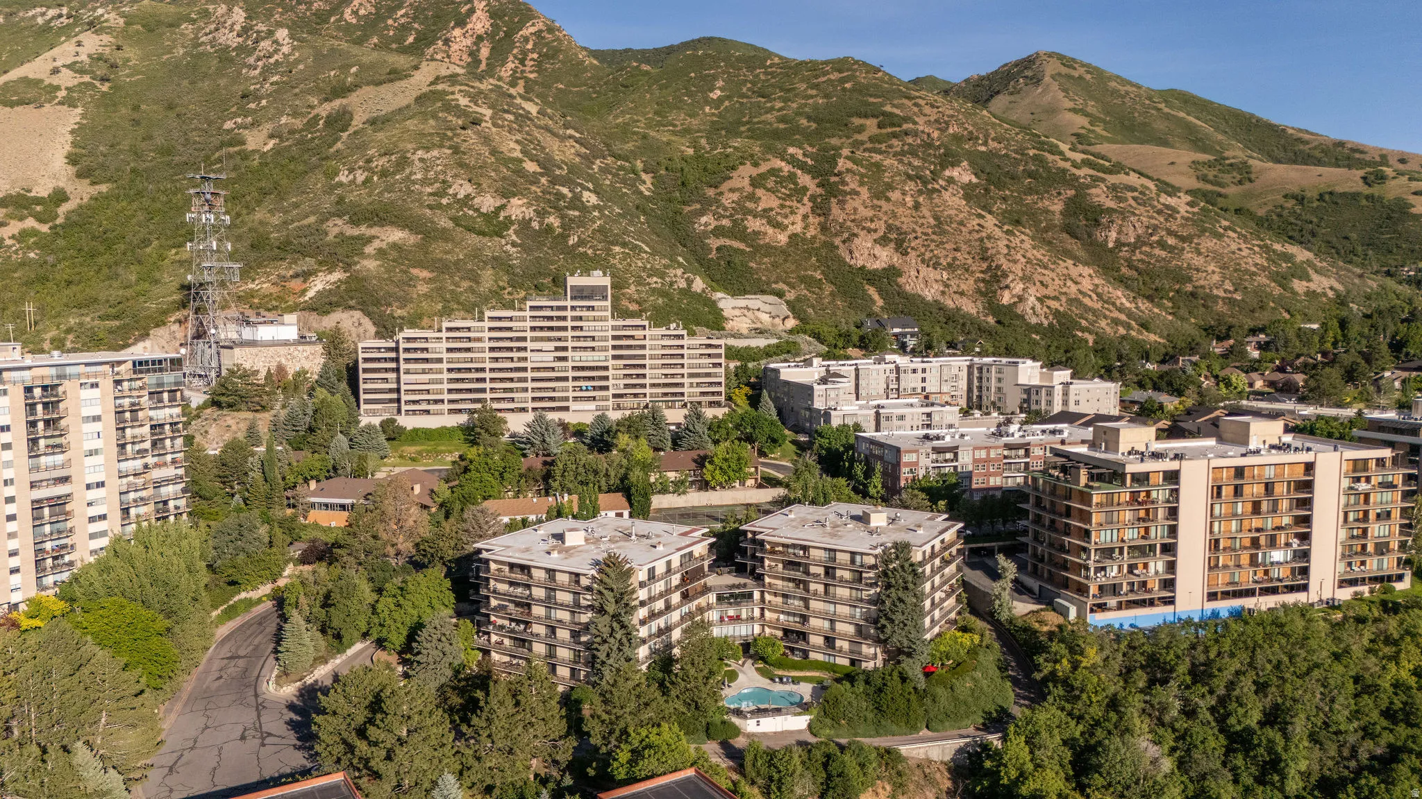 Expansive mountain backdrop framing multiple multi-story residential buildings