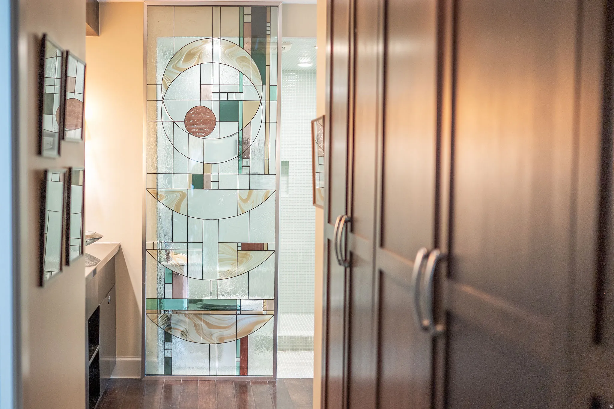 Sliding stained glass door featuring geometric patterns and varied glass textures
