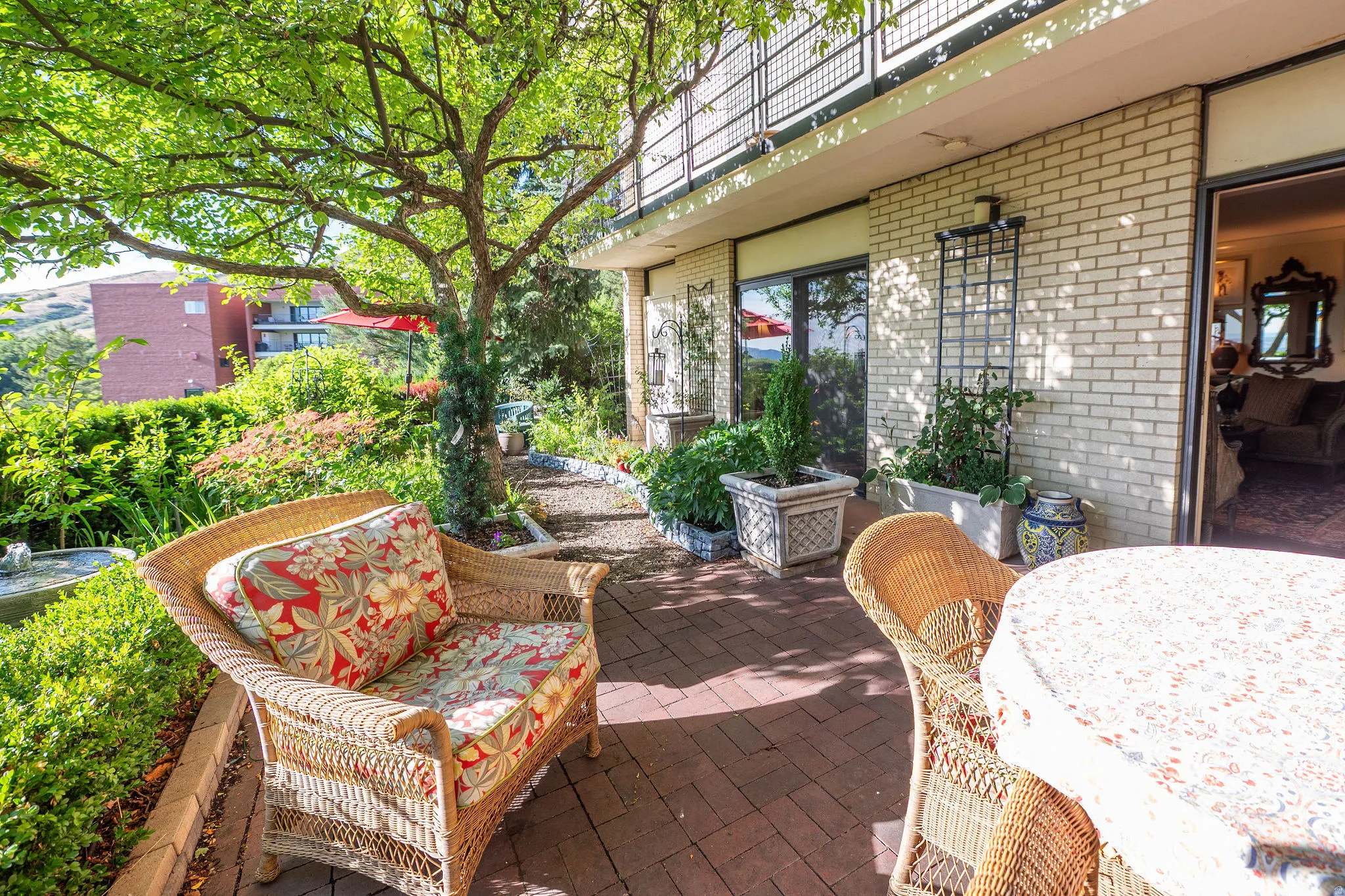 Paved brick patio with mature tree providing natural shade