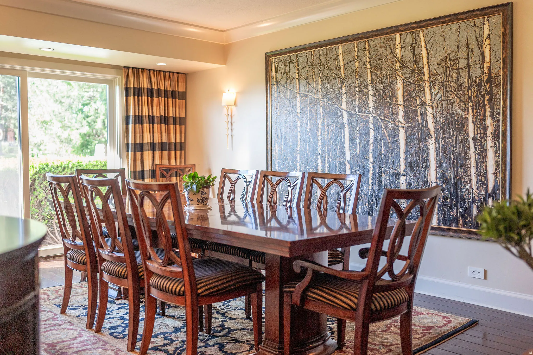 Formal dining area featuring rich wood-finish flooring and a substantial dining table