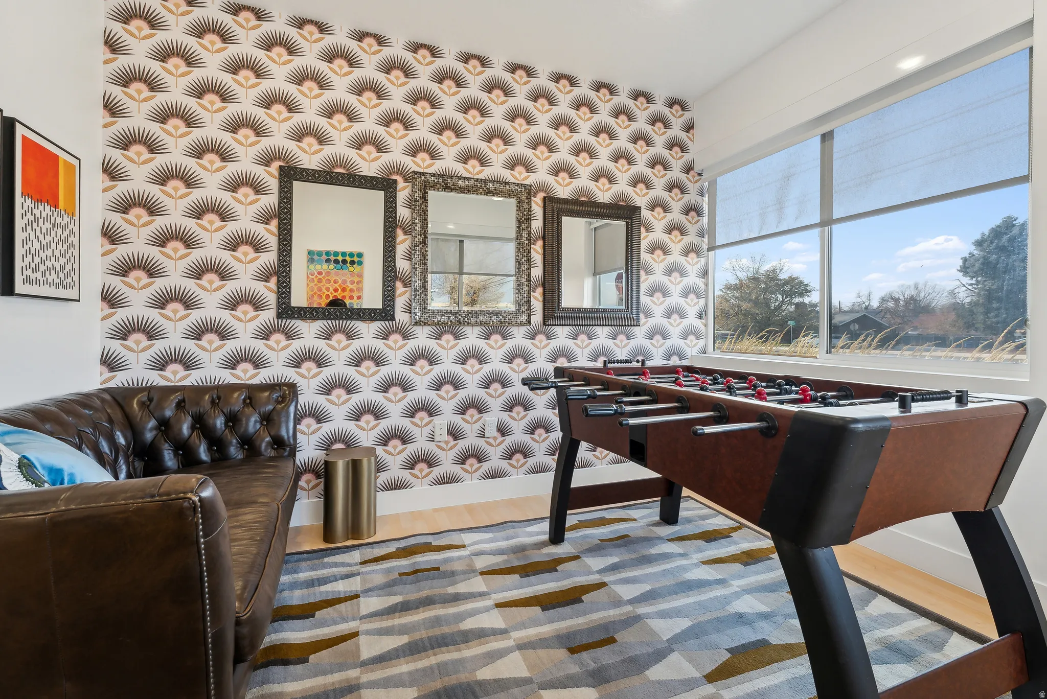 Room featuring patterned wallpaper, expansive windows, wood-finish flooring, and recessed lighting