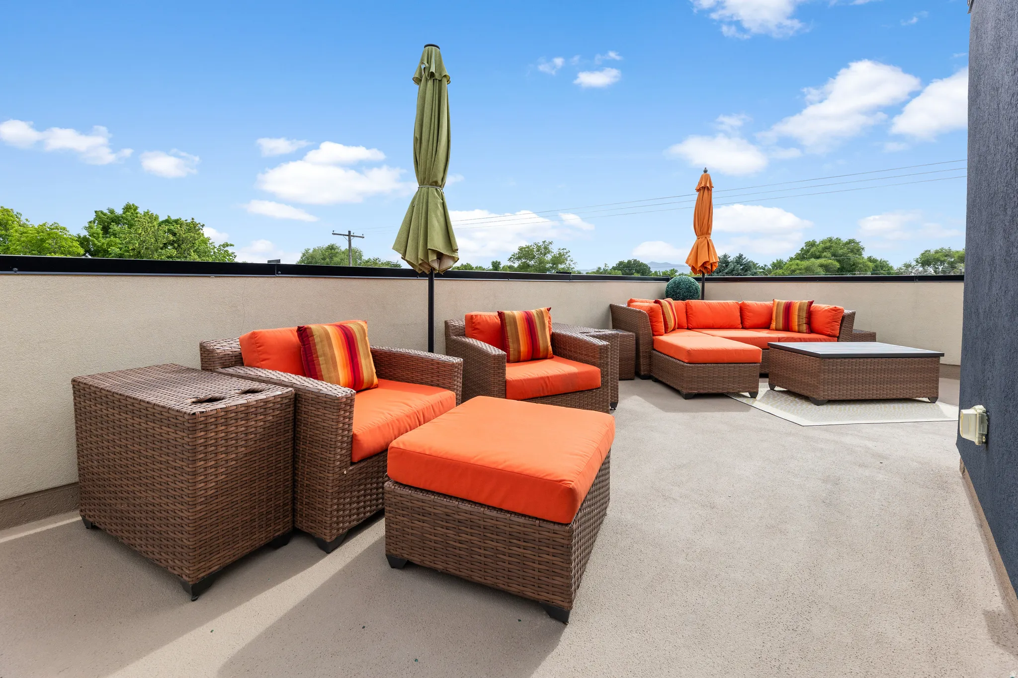 Spacious rooftop terrace featuring concrete flooring and a perimeter wall