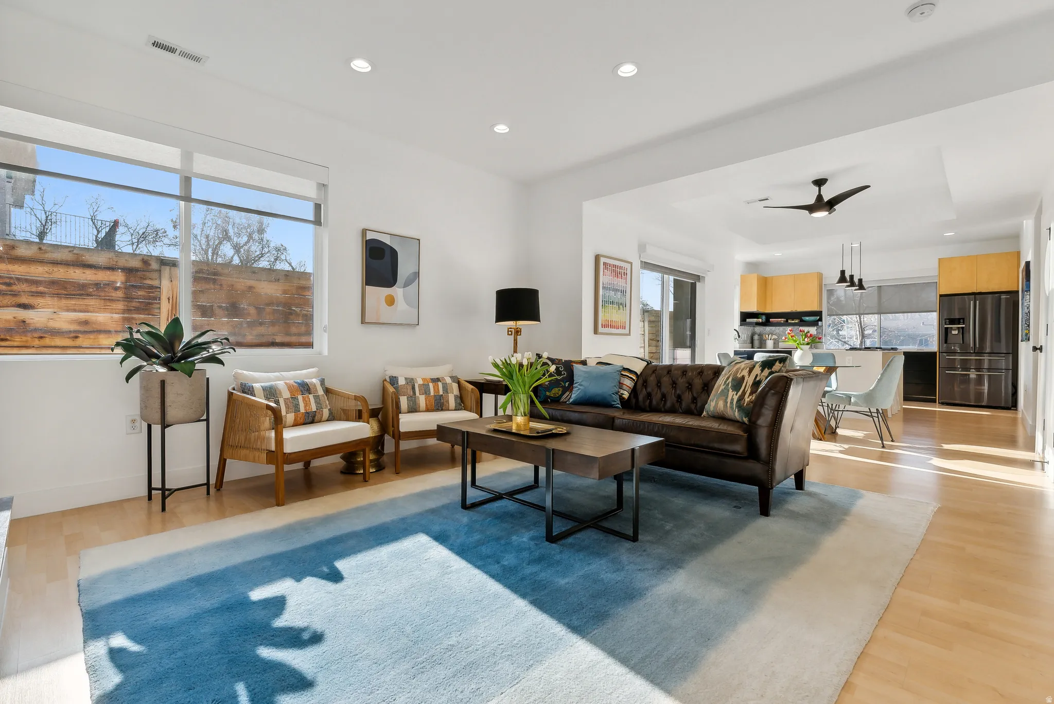 Open-concept living area featuring light wood-finish flooring and recessed lighting