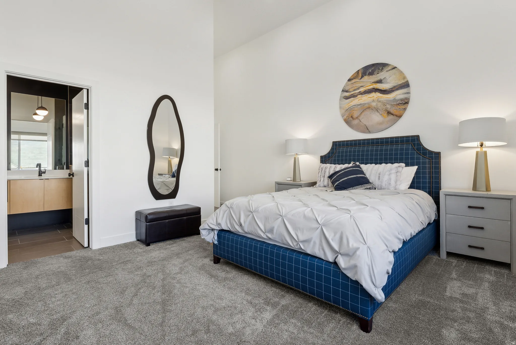 Carpeted bedroom with a vaulted ceiling